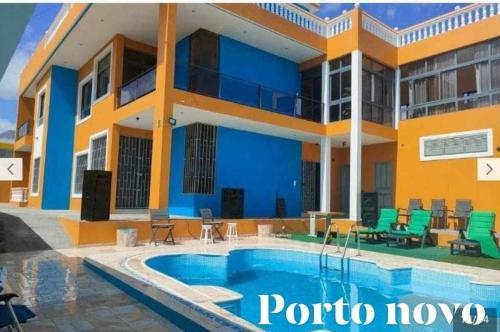a villa with a swimming pool in portico hoyo at Residencial Oliveira in Porto Novo