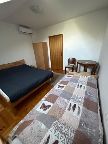 a bedroom with a bed with a quilt on it at Green Forest Visoko in Visoko
