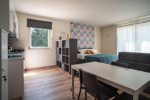 a living room with a couch and a table at Monolocale Moderno Valpolicella Verona - Jala in San Pietro in Cariano