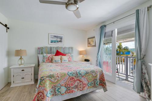 a bedroom with a bed and a balcony at Beach Dreams Resort in Bradenton Beach