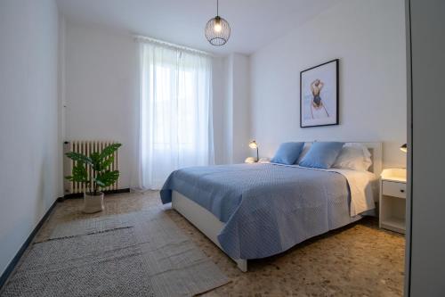 a white bedroom with a bed and a potted plant at 256 - Casa San Bernardo Vista Mare, nel verde di Sestri Levante in Sestri Levante