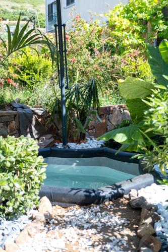 a small pool with a fountain in a garden at Minor Swing - appartment - CASA MONICA CARGESE - in Cargèse