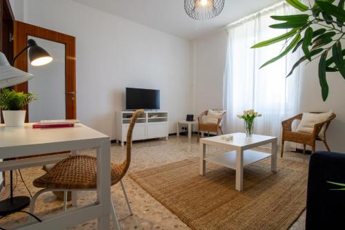 a living room with a chair and a table at 256 - Casa San Bernardo Vista Mare, nel verde di Sestri Levante in Sestri Levante