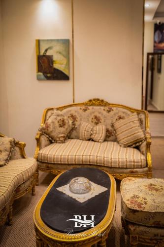 a living room with a couch and a table at Bianchi Hotel in Alexandria