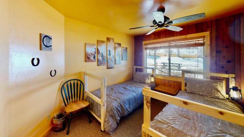 a bedroom with two bunk beds and a ceiling fan at Pack Creek ~ Farm House in Moab