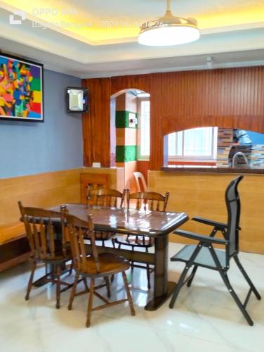 a dining room with a wooden table and chairs at Baguio Dreamz - Transient in Baguio