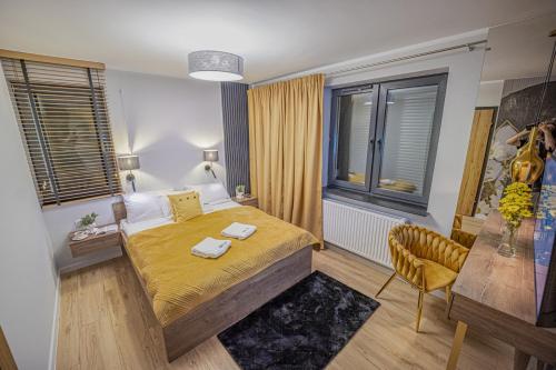 a bedroom with a bed and a chair in it at Apartament w Cieplicach Platinium in Jelenia Góra