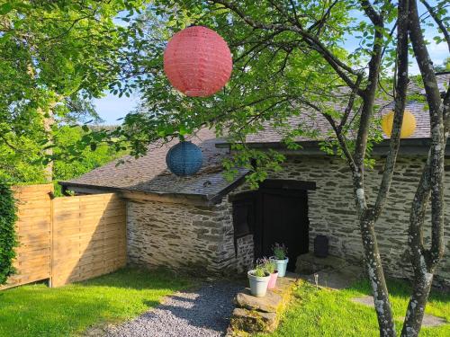 a house with a red lantern hanging from a tree at Lî Gurni in Houffalize