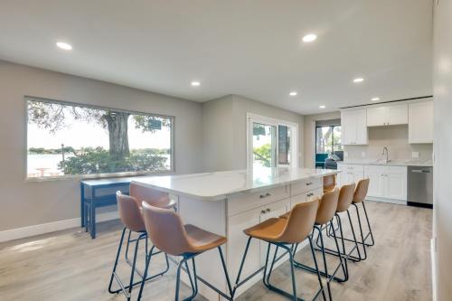 a kitchen with a large white island with brown chairs at 16 Mi to Manatee Viewing! Spacious Tampa Retreat in Tampa