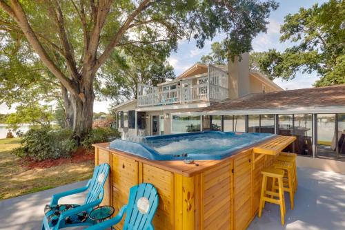 a large pool with two chairs and a house at 16 Mi to Manatee Viewing! Spacious Tampa Retreat in Tampa