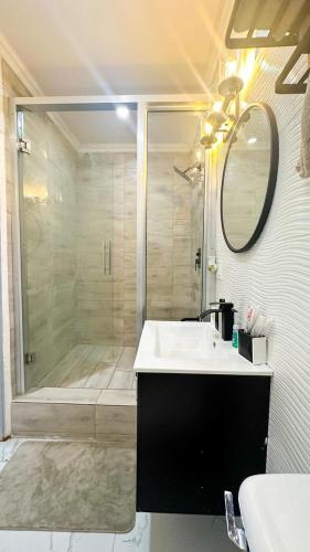 a bathroom with a shower and a sink and a tub at Luxurious 2 Bedroom Apartment- Georgetown in Georgetown