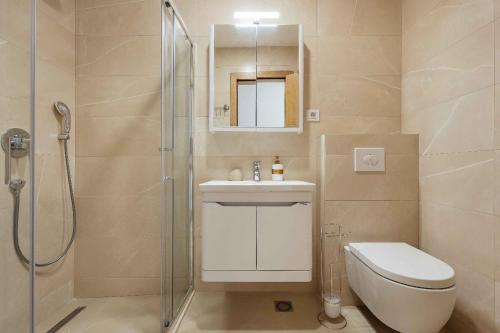 a bathroom with a shower and a toilet and a sink at Bella Vista Luxure Apartments in Baošići