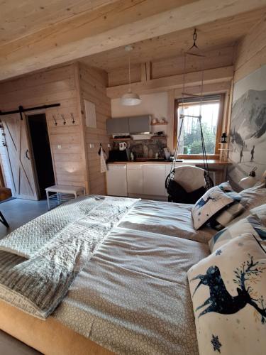 a large bed in a room with a kitchen at Pokoje Gościnne U Wandy in Zakopane