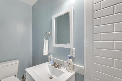 a bathroom with a white sink and a mirror at Walterboro House with Office Near Wildlife Center in Walterboro