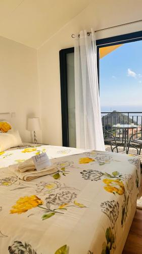 a bedroom with a bed with a view of the ocean at BoaVista- 2 bed house -COSY PANORAMIC -SEA - MOUNTAIN VIEW in Campanário