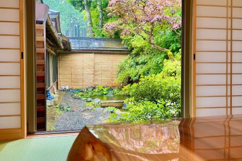 a view of a garden from a window at Koyasan Shukubo Yochiin in Koyasan