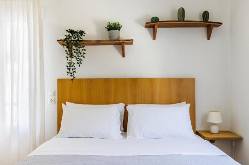 a bedroom with a bed with two white pillows at Aurora Skopelos in Skopelos Town
