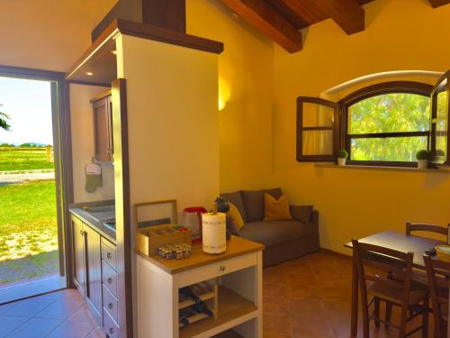 a living room with a couch and a table at Pianferrari Agriturismo in Maremma in Alberese