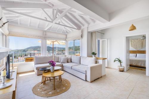 a living room with a couch and a table at Aurora Skopelos in Skopelos Town