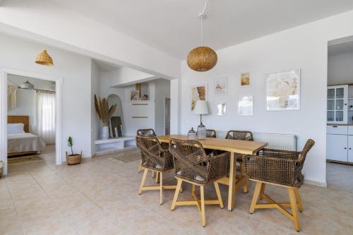 a dining room with a wooden table and chairs at Aurora Skopelos in Skopelos Town