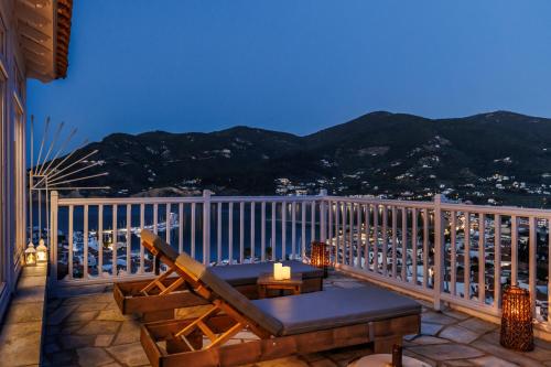 a balcony with a chair and a table on a balcony at Aurora Skopelos in Skopelos Town