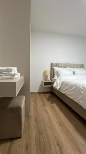 a bedroom with a bed and a wooden floor at Luxury Villa Mojito in Široki Brijeg