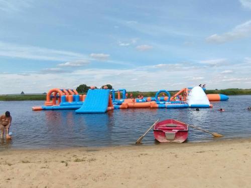 a group of inflatables in the water on a beach at Zielony Domek nad Biebrzą in Zabiele