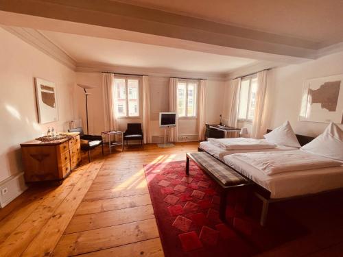 a bedroom with a large bed and a red rug at Poststation Zum Alten Forstamt in Morschen