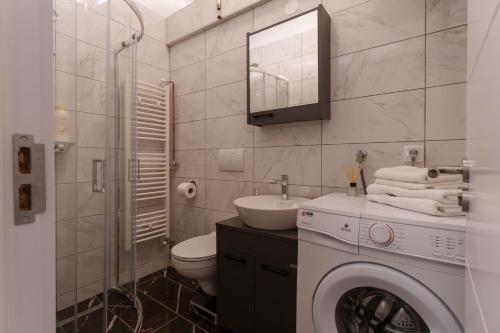 a bathroom with a washing machine and a sink at MaKi apartment in Belgrade