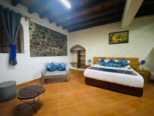 Postel nebo postele na pokoji v ubytování HOTEL EX HACIENDA EL MOLINO