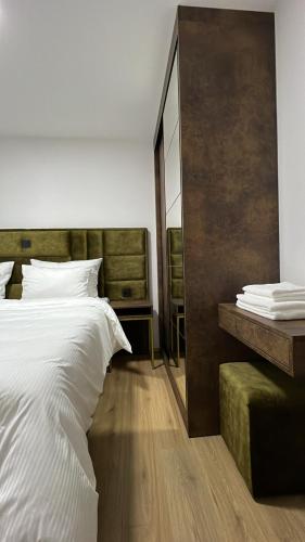 a bedroom with a large bed and a mirror at Luxury Villa Mojito in Široki Brijeg