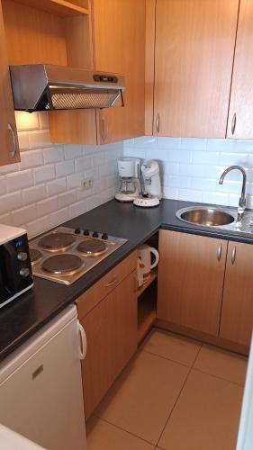 a kitchen with a sink and a counter top at Modern studio with beautiful sea view - 9th floor in Blankenberge
