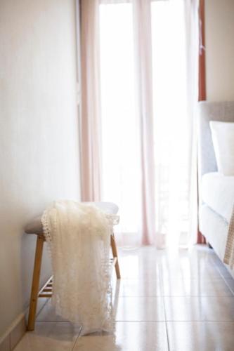 a chair with a white towel sitting in a room at Athina résidence in Nydri