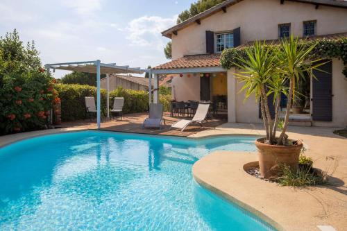 une piscine devant une maison dans l'établissement Villa Lumineuse avec Piscine Chambres OU Villa, à Saint-Georges-dʼOrques