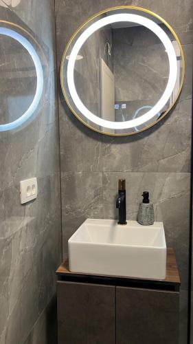 a bathroom with a white sink and a mirror at Luxury Villa Mojito in Široki Brijeg