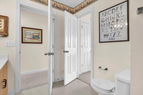a bathroom with a toilet and a sink at Prime Time in Caswell Beach