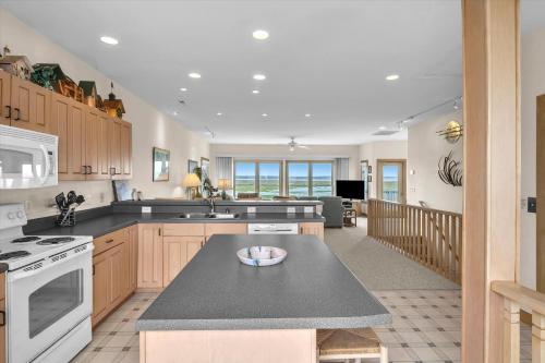 a kitchen with a counter top and a stove top oven at Prime Time in Caswell Beach