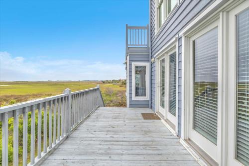 a wooden walkway leading to a house at Prime Time in Caswell Beach