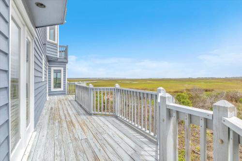 a house with a wooden deck with a view at Prime Time in Caswell Beach