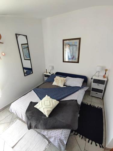 a bedroom with two beds and two mirrors at Santorini by Jasna in Vir