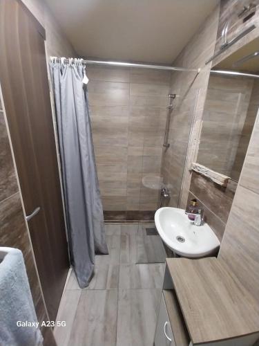 a bathroom with a white sink and a shower at JUDITA in Omiš