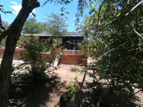 a house in the middle of a yard at Sunset on Kingfisher in Marloth Park