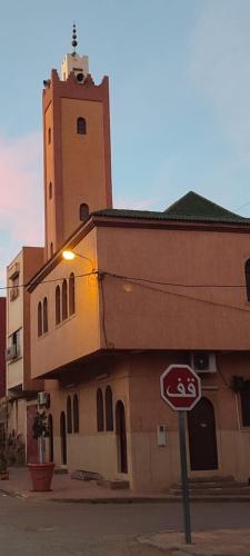a building with a stop sign in front of it at Résidence Les Deux Mules in Ahfir