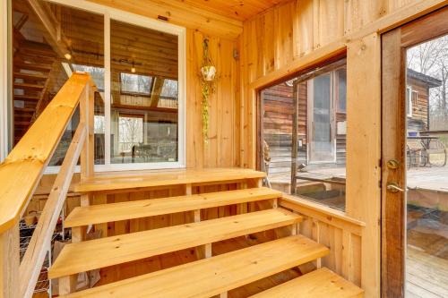 a wooden staircase in a log cabin at Cozy Home on 10 Acres Yellowstone in Vermont in Townshend