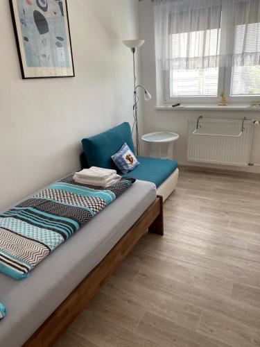 a small bedroom with a bed and a chair at Ubytování U Truhlářů Šaldorf in Nový Šaldorf
