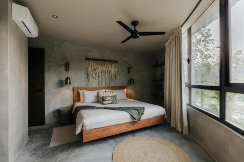 a bedroom with a bed and a ceiling fan at Esencia Villas Tulum Priv Pool Concierge in Tulum