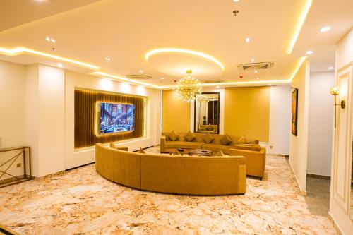 a living room with a couch and a table at Pavilion Suites - Premium ApartHotel in Bahria Town in Rawalpindi