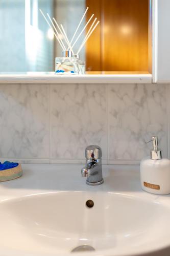 a bathroom sink with a faucet on top of it at Makri Beach Villa in Mákri