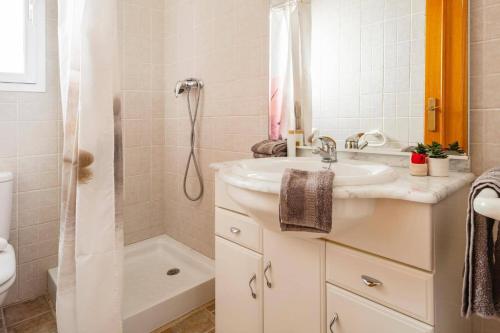 a bathroom with a sink and a shower at Villa Dalia by Villa Plus in Beniarbeig