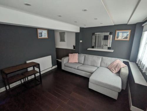 a living room with a couch and a table at Free Parking, 1 bed flat Park street in Weymouth